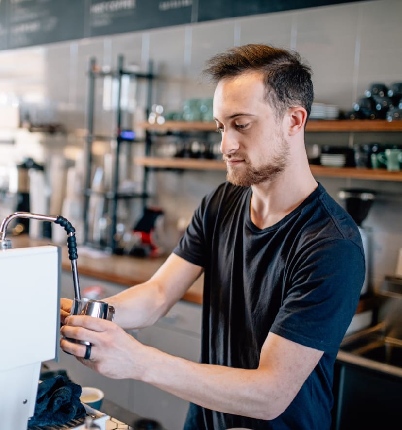 A barista working at his new job making coffees at a local Southern Shoalhaven cafe.