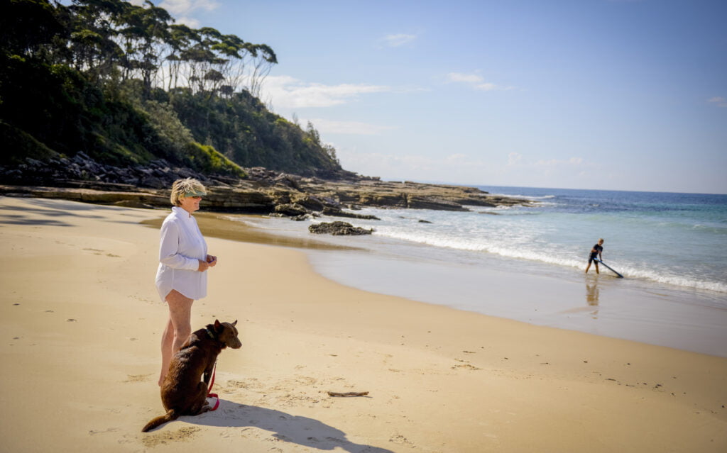 A woman at a dog-friendly beach in the South Shoalhaven