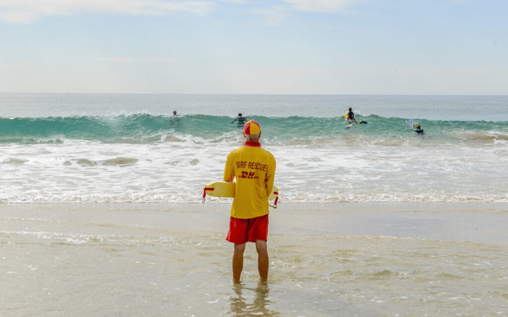 A surf livesaver patrolling Mollymook beach